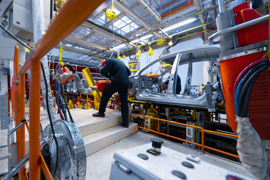 Workers assemble car. modern automated assembly line for cars. latest technological neutral technologies of production of cars at plant. Assembly of cars on conveyor